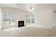 Large living room featuring a fireplace, ceiling fan and multiple windows at 402 Halls Mill Dr, Cary, NC 27519