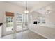 Open-concept living room featuring a fireplace, large windows, and access to the backyard patio at 402 Halls Mill Dr, Cary, NC 27519