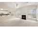 Cozy living room with fireplace open to the kitchen, flooded with natural light at 402 Halls Mill Dr, Cary, NC 27519