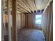 Bright room under construction features exposed wood framing and windows for natural lighting at 433 Old Fashioned Way, Lillington, NC 27546