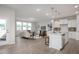 Spacious and well-lit living room that connects to an open kitchen featuring a large kitchen island at 433 Old Fashioned Way, Lillington, NC 27546