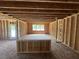Unfinished living room displaying exposed wood framing and ample space with natural lighting at 433 Old Fashioned Way, Lillington, NC 27546