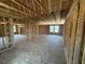 Expansive unfinished room showing exposed wood framing and plentiful windows for natural light at 433 Old Fashioned Way, Lillington, NC 27546