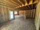 Unfinished living area featuring open framework and a rear entrance, providing plenty of potential at 433 Old Fashioned Way, Lillington, NC 27546