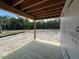 Newly constructed patio featuring exposed framing and a view of the surrounding undeveloped landscape at 433 Old Fashioned Way, Lillington, NC 27546