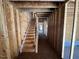 Unfinished wooden staircase inside a home under construction, showing exposed framing at 433 Old Fashioned Way, Lillington, NC 27546