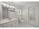 Bright bathroom features white hexagon tile, vanity, toilet, and mirrored door to shower at 441 Fieldstone Dr, Burlington, NC 27215