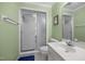 Small bathroom with green walls, white vanity, glass shower, and tiled floor at 441 Fieldstone Dr, Burlington, NC 27215