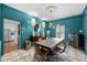 Modern dining room boasts an eye-catching chandelier, bold blue walls, and a chic zebra-print rug at 441 Fieldstone Dr, Burlington, NC 27215