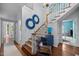 Elegant foyer featuring a staircase, hardwood floors, chandelier, and stylish decor with an entry to the dining room at 441 Fieldstone Dr, Burlington, NC 27215