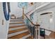 Elegant foyer featuring a staircase, hardwood floors, chandelier, and stylish decor with an entry to the dining room at 441 Fieldstone Dr, Burlington, NC 27215