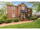 Charming brick two-story home featuring a well-manicured lawn and a welcoming front entrance with a black awning at 441 Fieldstone Dr, Burlington, NC 27215