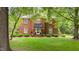 Charming brick two-story home featuring a well-manicured lawn and a welcoming front entrance with a black awning at 441 Fieldstone Dr, Burlington, NC 27215
