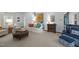 Comfortable living room with carpet, a white sofa, colorful pillows, and a leather ottoman at 441 Fieldstone Dr, Burlington, NC 27215