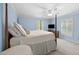 Light-filled main bedroom with blue walls, neutral carpet, and bright white linens at 441 Fieldstone Dr, Burlington, NC 27215