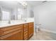 Bathroom featuring a double vanity with wood cabinets, a large mirror, and a separate toilet area at 4502 Joe Cotton Dr, Knightdale, NC 27545