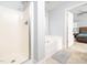 Bathroom with shower, soaking tub, and a glimpse into the main bedroom, offering a spa-like experience at 4502 Joe Cotton Dr, Knightdale, NC 27545
