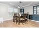 Dining room with table set for six, wooden chairs, custom cabinetry, and natural light from a large window at 4502 Joe Cotton Dr, Knightdale, NC 27545