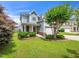 Charming two-story home with manicured lawn, flowering trees, and a welcoming front porch at 4502 Joe Cotton Dr, Knightdale, NC 27545