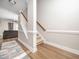 Bright foyer with hardwood floors, a staircase with white railings, and views into the living area at 4502 Joe Cotton Dr, Knightdale, NC 27545
