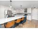 Bright kitchen with white cabinets, stainless appliances, and a large island with seating for a modern look at 4502 Joe Cotton Dr, Knightdale, NC 27545