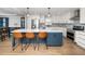 Modern kitchen featuring a large island with bar seating, white cabinets, and stainless steel appliances at 4502 Joe Cotton Dr, Knightdale, NC 27545