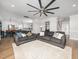 Open-concept living area flows into the kitchen, featuring hardwood floors and a large ceiling fan at 4502 Joe Cotton Dr, Knightdale, NC 27545