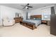 Spacious main bedroom featuring a ceiling fan, a large window, a dresser, and a bed with wood accents at 4502 Joe Cotton Dr, Knightdale, NC 27545