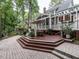 A spacious deck features a dining area and lush surroundings, creating an inviting outdoor living space at 4716 Shadow Ridge Ct, Holly Springs, NC 27540