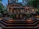 Multi-tiered deck features an umbrella-shaded dining area, ideal for outdoor gatherings in a serene, wooded setting at 4716 Shadow Ridge Ct, Holly Springs, NC 27540