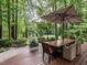 Inviting outdoor dining area on wood deck, perfect for entertaining with beautiful golf course views at 4716 Shadow Ridge Ct, Holly Springs, NC 27540