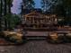 Expansive backyard with a sprawling patio, perfect for outdoor dining and entertaining under the ambient glow of string lights at 4716 Shadow Ridge Ct, Holly Springs, NC 27540