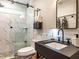 A bathroom with a sleek shower, modern vanity, and marble tile accents at 4716 Shadow Ridge Ct, Holly Springs, NC 27540