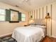 Cozy bedroom with striped accent wall, window shutters, and unique lighting at 4716 Shadow Ridge Ct, Holly Springs, NC 27540