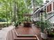 Outdoor deck with table and chairs surrounded by lush landscaping at 4716 Shadow Ridge Ct, Holly Springs, NC 27540