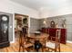 Inviting dining room with hardwood floors, gray wainscoting, and view to the living room at 4716 Shadow Ridge Ct, Holly Springs, NC 27540