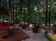 Serene backyard oasis featuring a modern fire pit, stylish seating, and lush surroundings, creating an inviting outdoor retreat at 4716 Shadow Ridge Ct, Holly Springs, NC 27540
