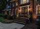 Elegant brick home showcasing a stately front door and meticulously landscaped entryway, radiating timeless charm and curb appeal at 4716 Shadow Ridge Ct, Holly Springs, NC 27540
