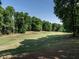 Picture-perfect golf course view surrounded by mature trees with a serene, well-manicured landscape at 4716 Shadow Ridge Ct, Holly Springs, NC 27540