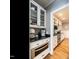 A kitchen featuring stainless steel appliances and a microwave built into the custom cabinets with hardwood floors at 4716 Shadow Ridge Ct, Holly Springs, NC 27540