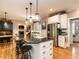 Well-equipped kitchen with a large island, breakfast bar, and stainless steel appliances at 4716 Shadow Ridge Ct, Holly Springs, NC 27540