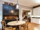 A kitchen featuring a small, round table next to a rustic-style hutch with storage, hardwood floors, and access to a living area at 4716 Shadow Ridge Ct, Holly Springs, NC 27540
