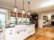 Elegant kitchen island with breakfast bar, stainless sink, and views of the breakfast area at 4716 Shadow Ridge Ct, Holly Springs, NC 27540