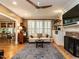 Comfortable living room with hardwood floors, fireplace, built-ins, and large windows at 4716 Shadow Ridge Ct, Holly Springs, NC 27540