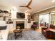 Cozy living room with fireplace, built-in shelves, hardwood floors and sliding door to dining area at 4716 Shadow Ridge Ct, Holly Springs, NC 27540