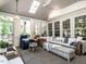 Enclosed porch with wicker furniture, skylight, and large windows at 4716 Shadow Ridge Ct, Holly Springs, NC 27540