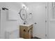 Well-lit bathroom features a vanity with wood cabinets, sleek fixtures, and a toilet at 5110 Old Well St, Durham, NC 27704