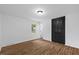 Bedroom features wood-look floors, a window, and large closet for all your storage needs at 5110 Old Well St, Durham, NC 27704