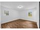 Bright bedroom with wood floors, two windows, and ample space for relaxation and rest at 5110 Old Well St, Durham, NC 27704
