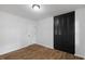 Well-lit bedroom with wood-look floors and a dark closet offering ample storage space at 5110 Old Well St, Durham, NC 27704